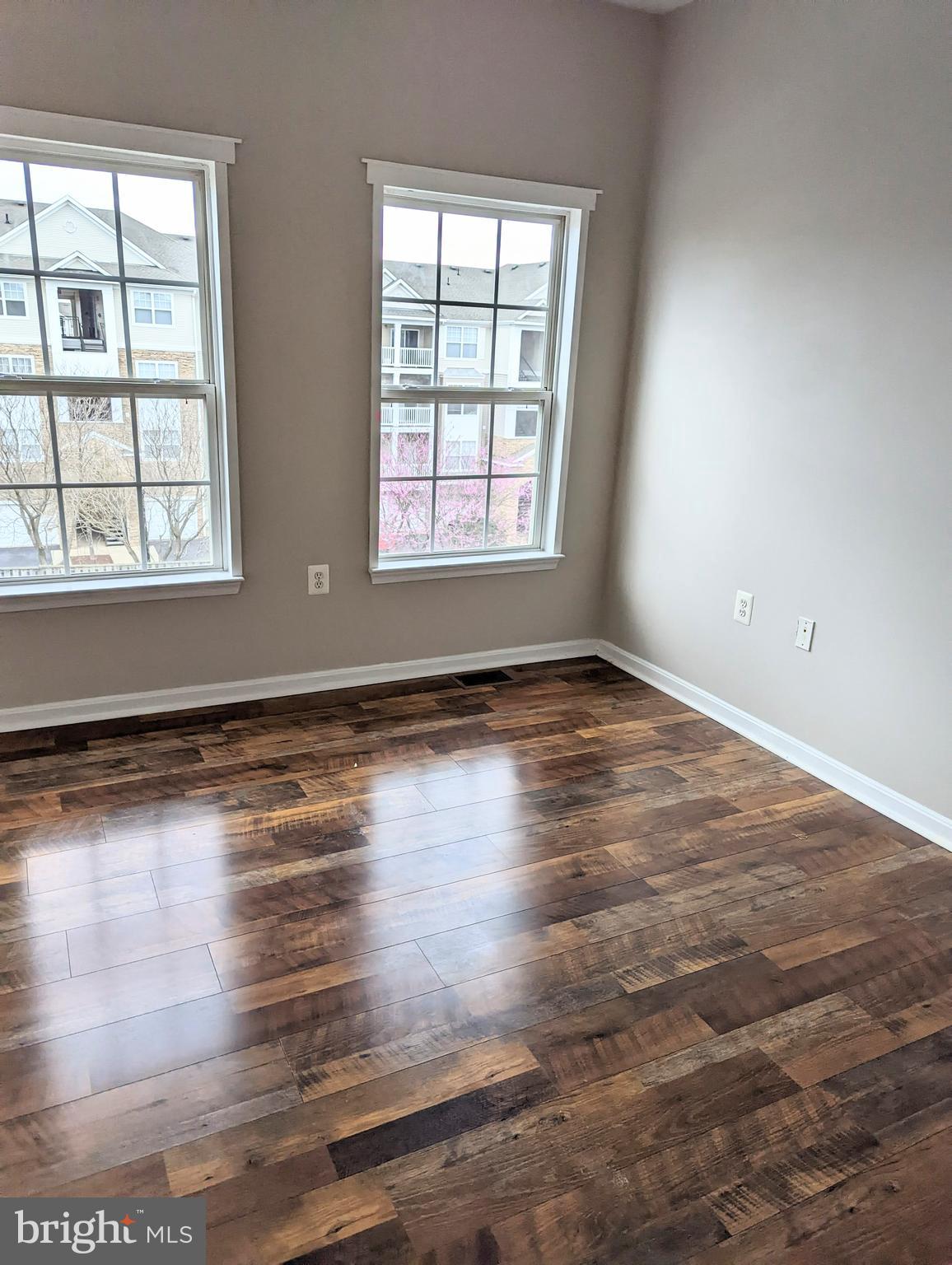 21765 Ascot Court Ashburn, VA 20147 - Photo 24 of 32 an empty room with wooden floor and windows