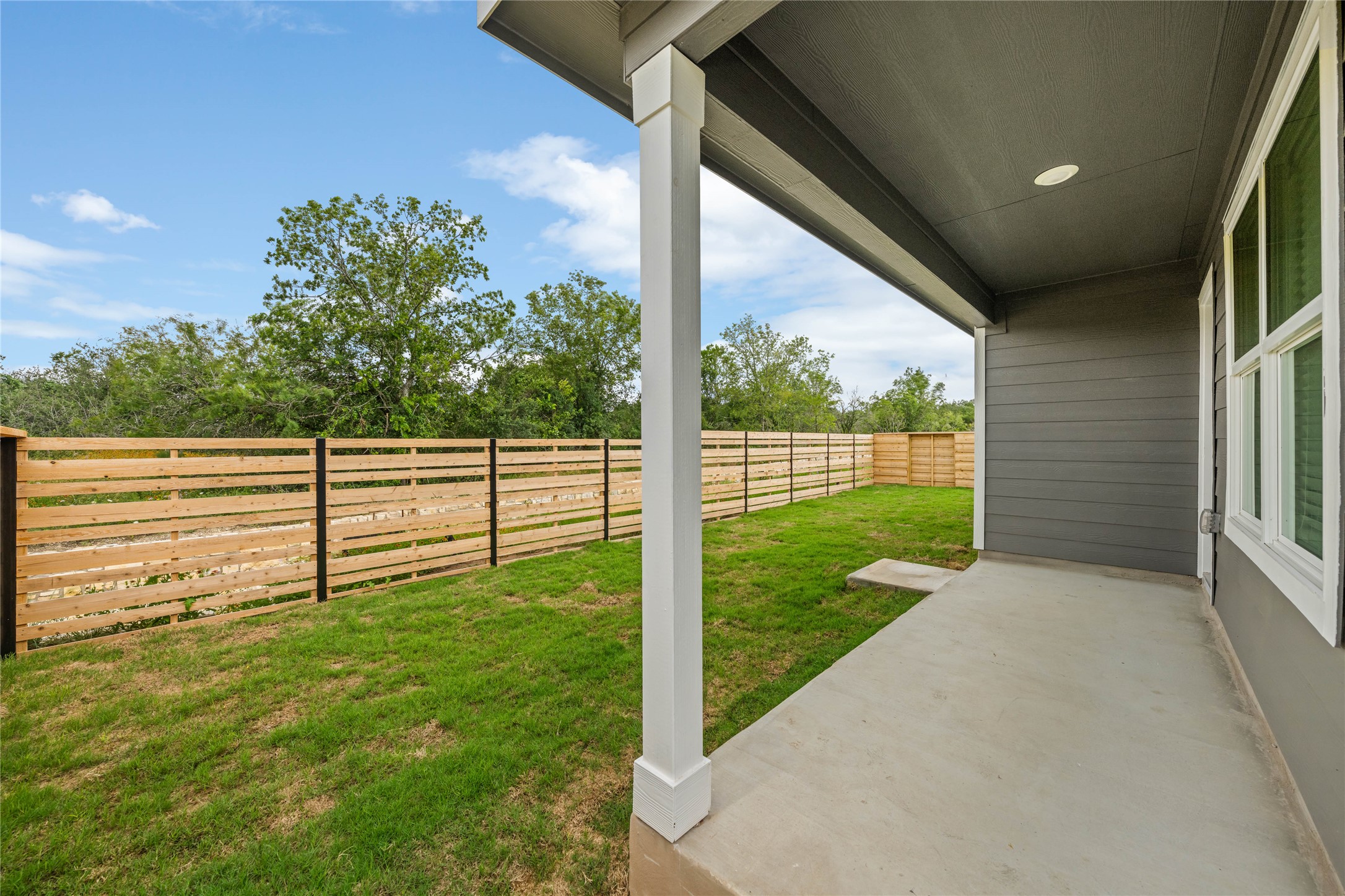 115 Parsons Kyle, TX 78640 - Photo 15 of 18 A well-maintained lawn and sturdy wood fencing define this welcoming backyard space.