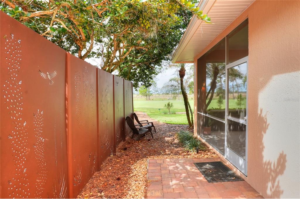 2968 Plantation Road Winter Haven, FL 33884 - Photo 57 of 81 a view of a backyard with table and chairs and floor to ceiling window