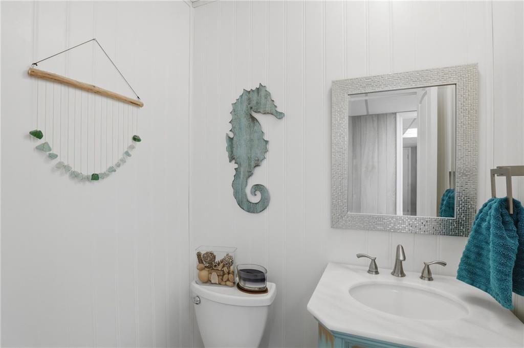 338 Arbour Way Suwanee, GA 30024 - Photo 18 of 32 a bathroom with a toilet sink and mirror