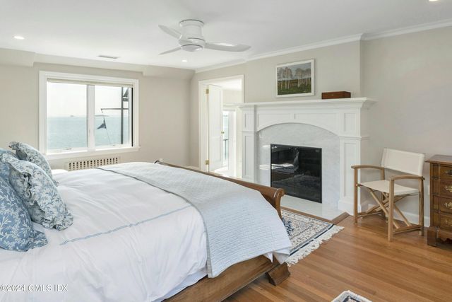 a bedroom with a bed and a fireplace