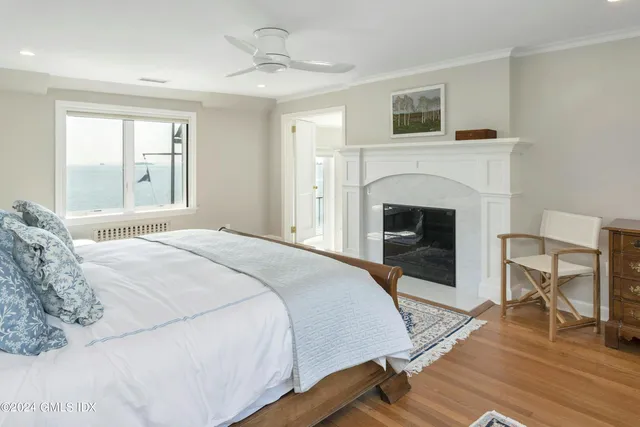 a bedroom with a bed and a fireplace