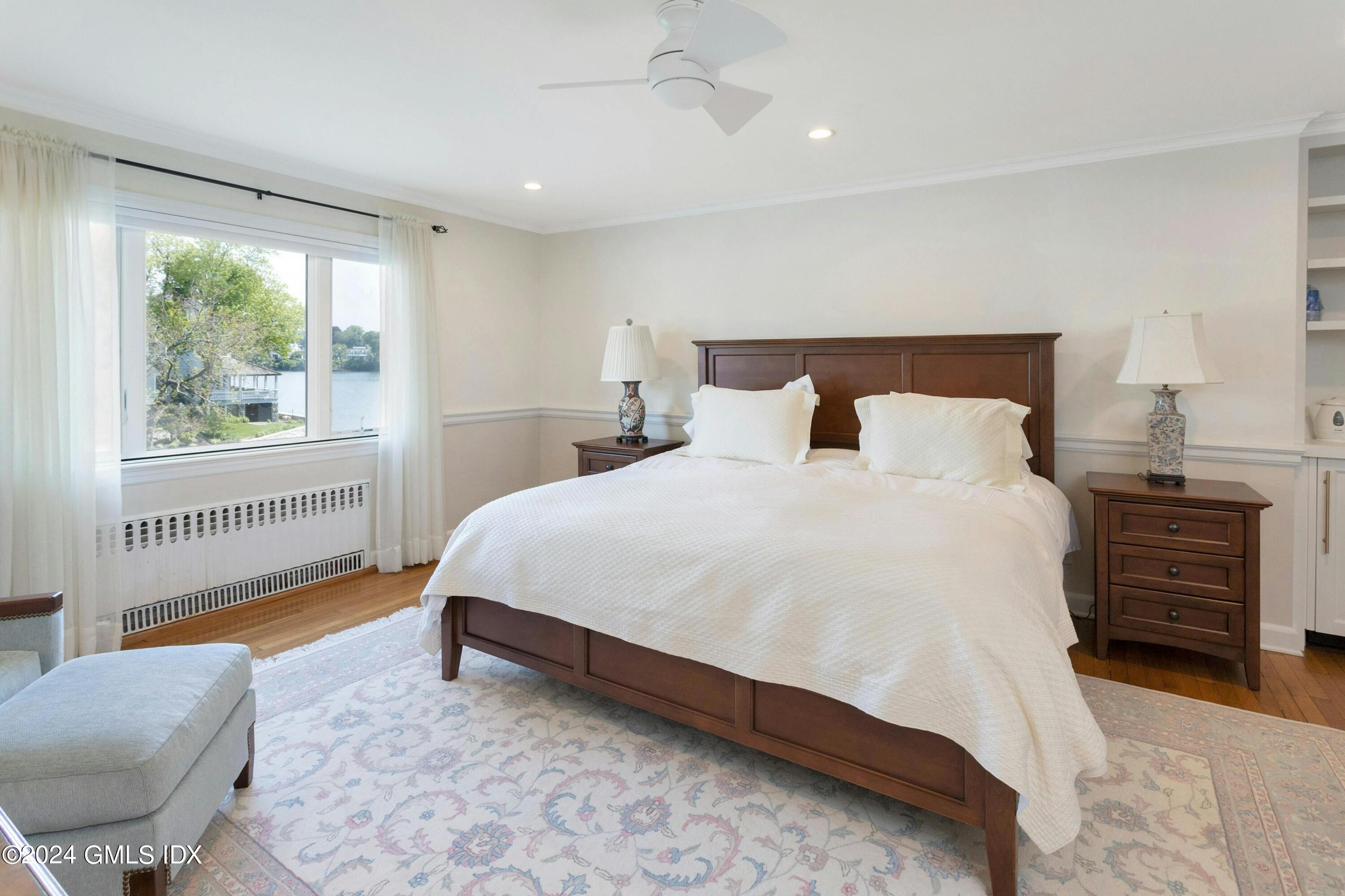 36-38 Game Cock Road Greenwich, CT 06830 - Photo 14 of 34 a bed sitting in a bedroom next to a window