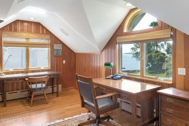 a living room with a table chairs and a dining table