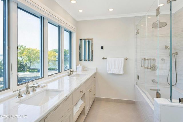 a bathroom with a granite countertop sink mirror and a bathtub