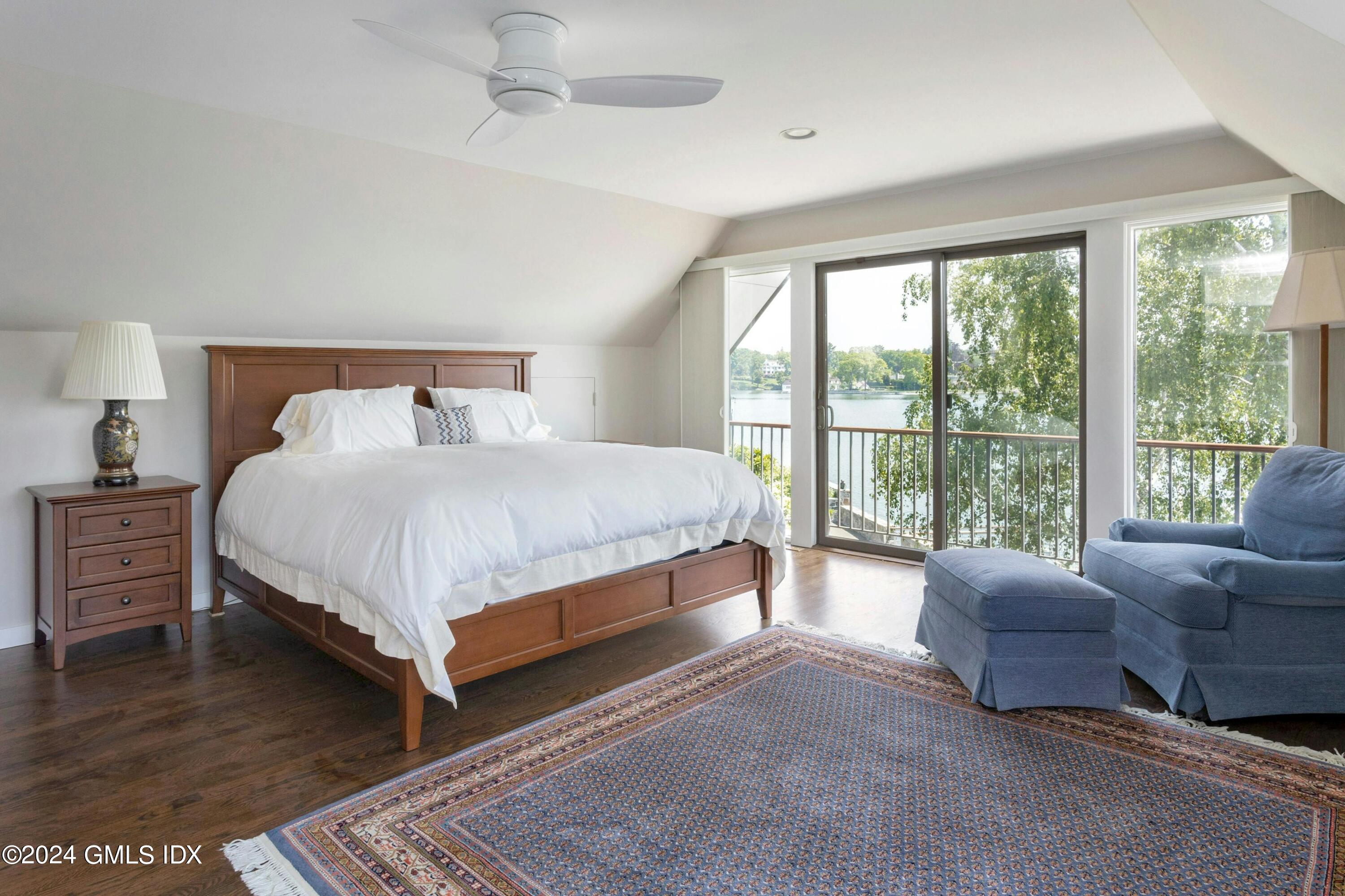 36-38 Game Cock Road Greenwich, CT 06830 - Photo 20 of 34 a bedroom with a bed couch and a large window