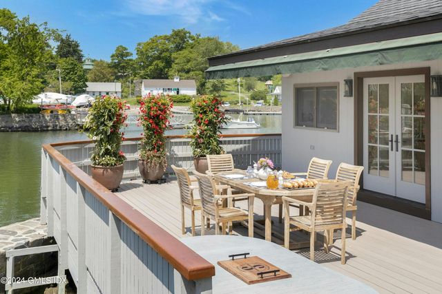 a view of a chairs and table in the balcony