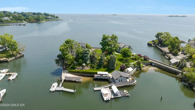 a view of a lake with a floor to ceiling window and a table