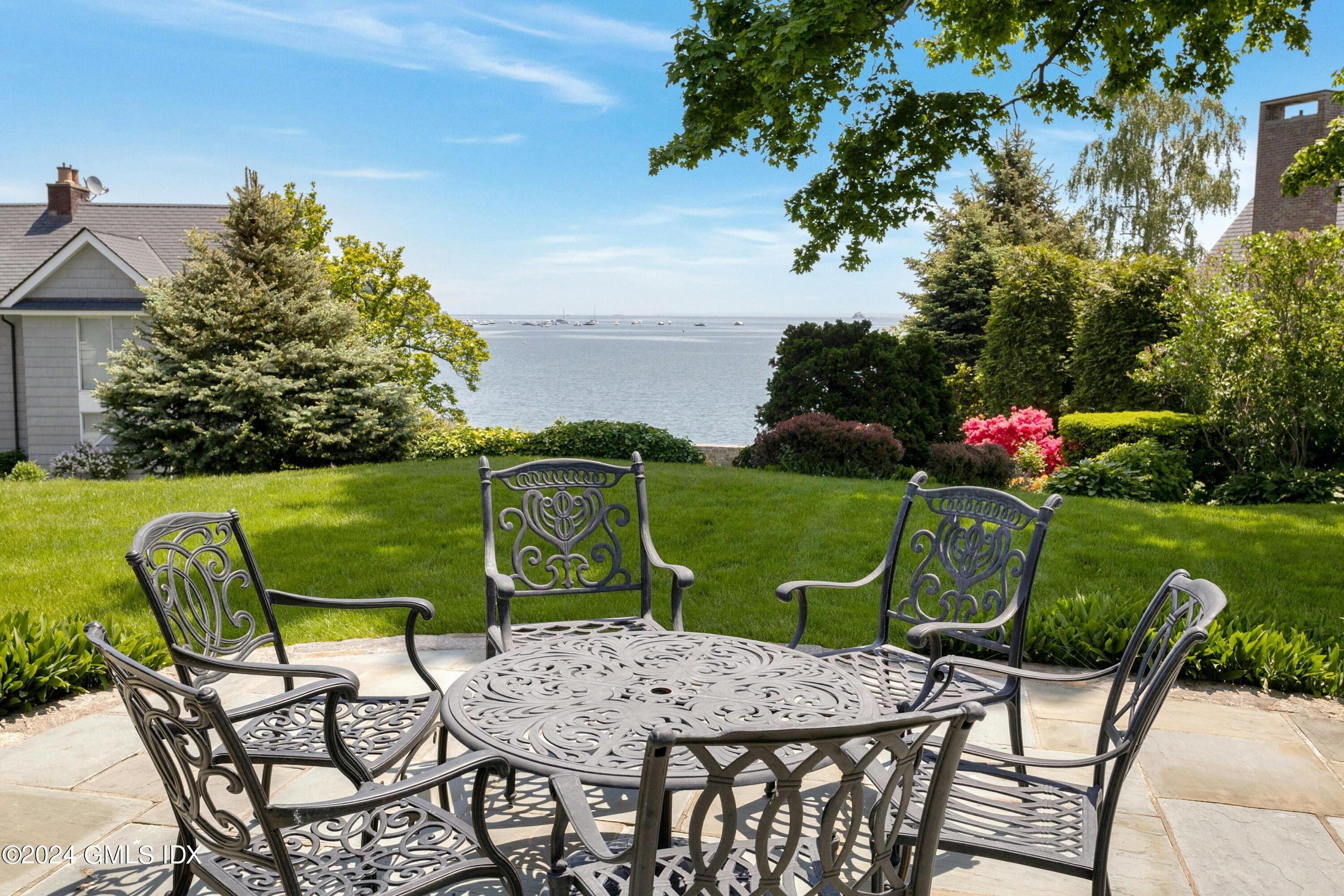 36-38 Game Cock Road Greenwich, CT 06830 - Photo 7 of 34 a view of a chairs and table in patio with a yard