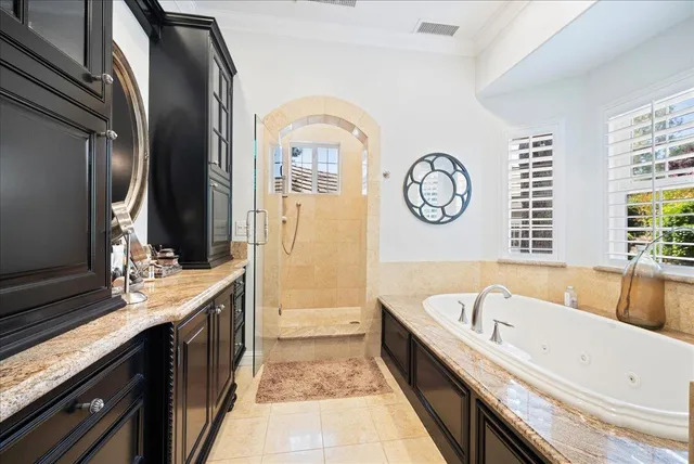 a kitchen with stainless steel appliances wooden floor and a window