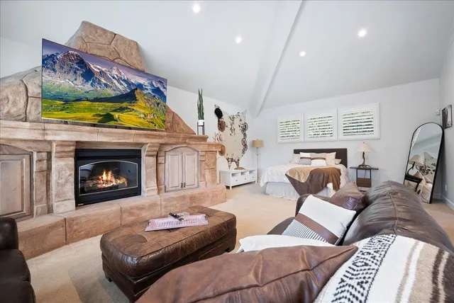 a spacious bedroom with a bed and a window