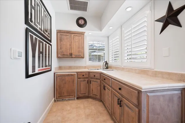a bathroom with a sink a mirror and a window