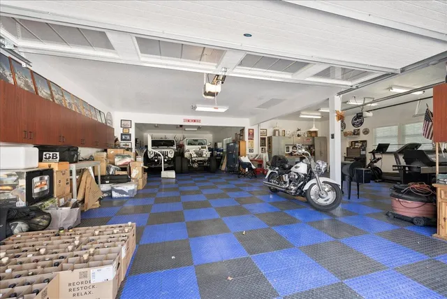 a view of a patio with a dining table and chairs with wooden floor and fence
