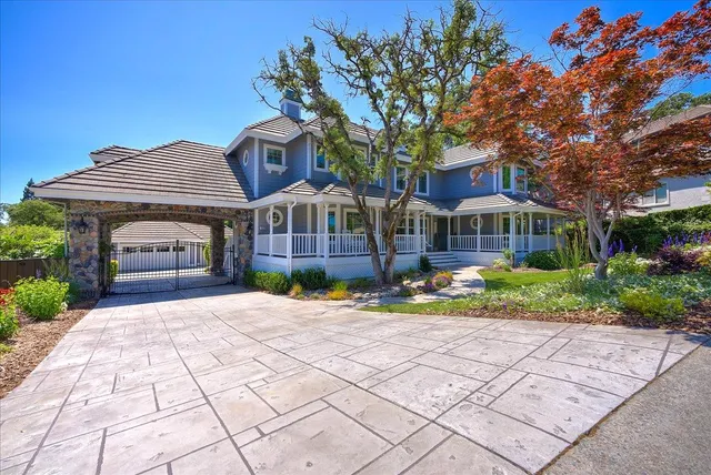a view of a house with a small yard and plants