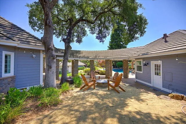 a swimming pool with outdoor seating and yard