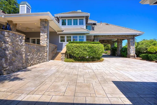 an aerial view of a house with a yard and lake view