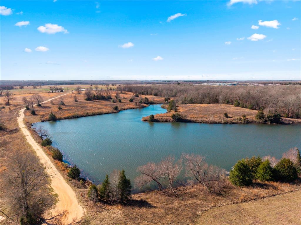 Tbd Tbd Us-271 Mount, Unit 12 Mount Pleasant, TX 75455 - Photo 18 of 20 a view of a lake with houses in the back