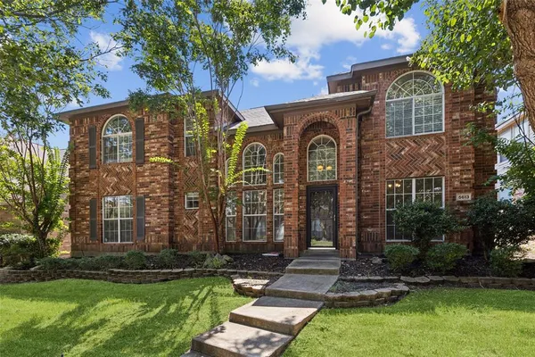 front view of a house with a yard