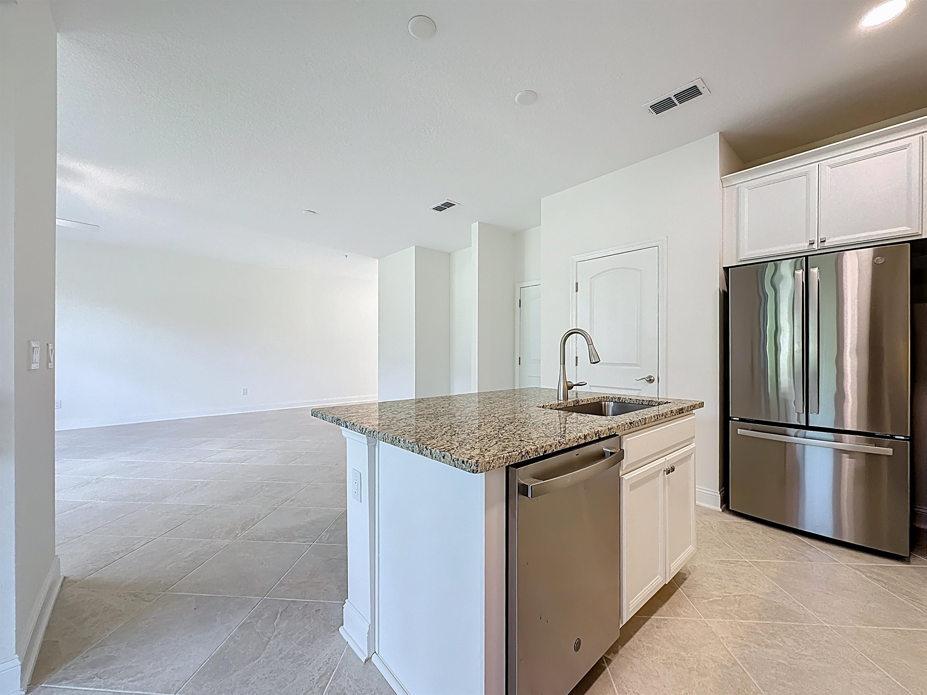 251 Grand Ravine Drive St. Augustine, FL 32086 - Photo 11 of 37 a kitchen with stainless steel appliances granite countertop a sink stove and refrigerator