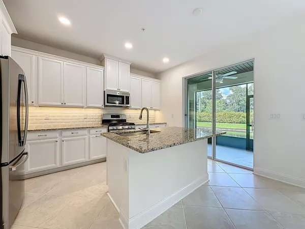 a kitchen that has a sink and a stove