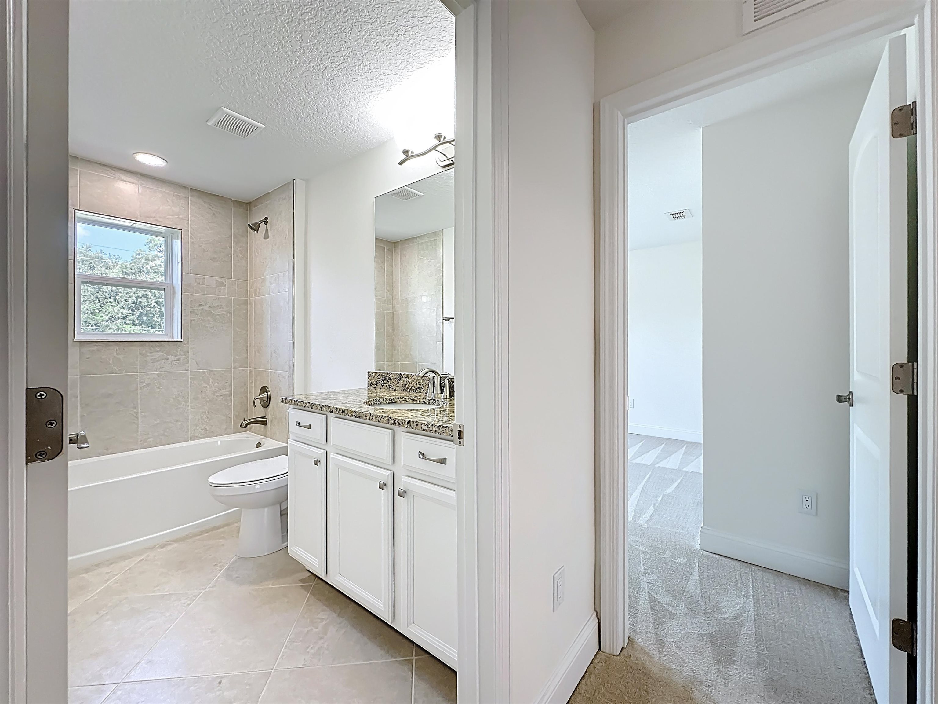 251 Grand Ravine Drive St. Augustine, FL 32086 - Photo 21 of 37 a bathroom with a toilet a bath tub and a sink