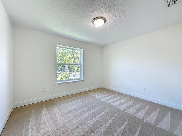 a bathroom with a granite countertop sink a toilet a mirror a bathtub and shower