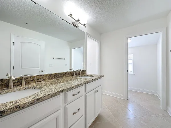 a view of a white house with a yard