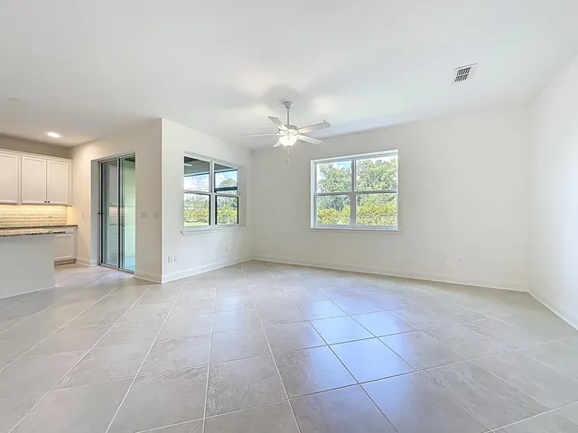 a view of a livingroom with furniture and a ceiling fan