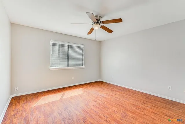 a view of a park with bench and trees