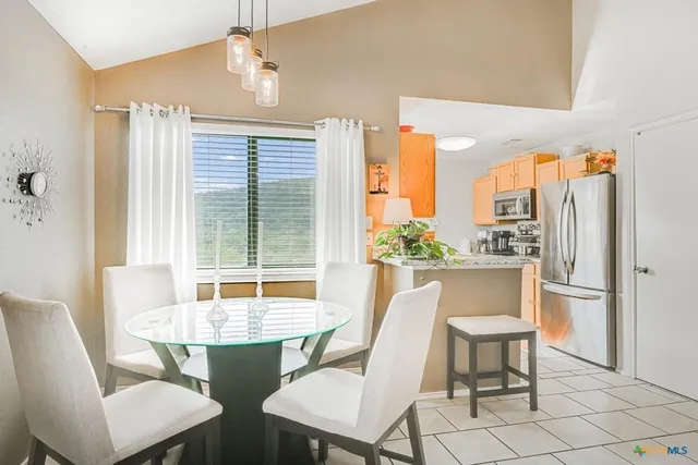 a view of a dining room with furniture window and outside view