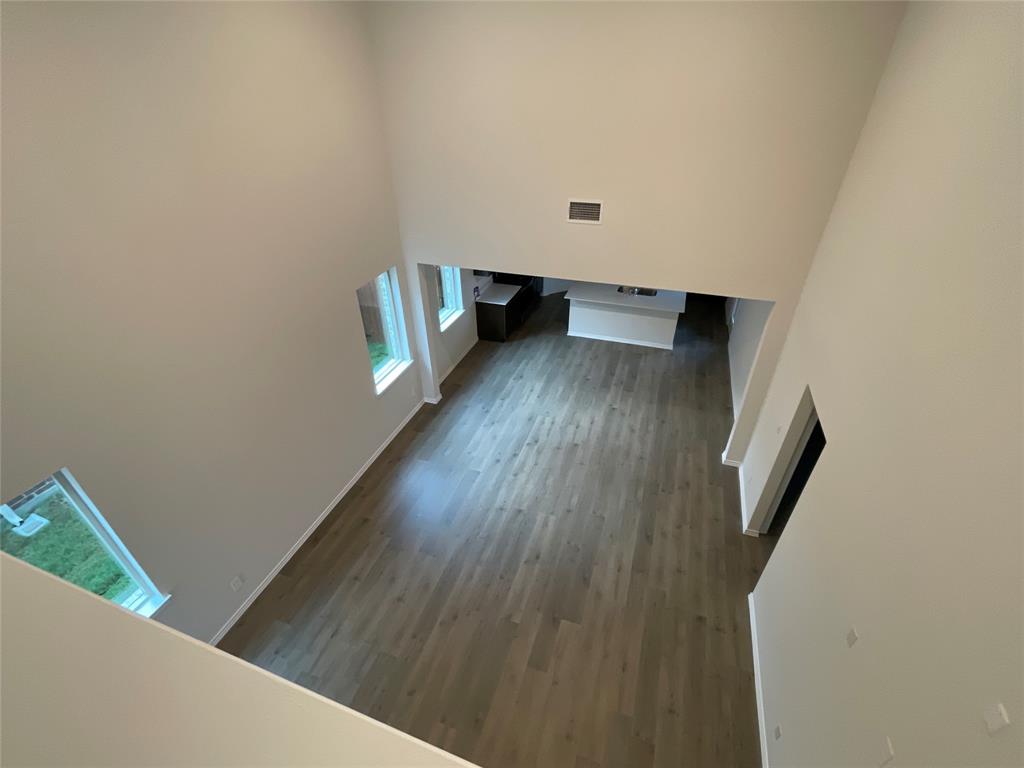 657 Chipper Trail Lavon, TX 75166 - Photo 13 of 24 a view of a hallway with wooden floor