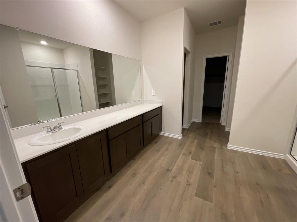 657 Chipper Trail Lavon, TX 75166 - Photo 15 of 24 a bathroom with a double vanity sink and mirror