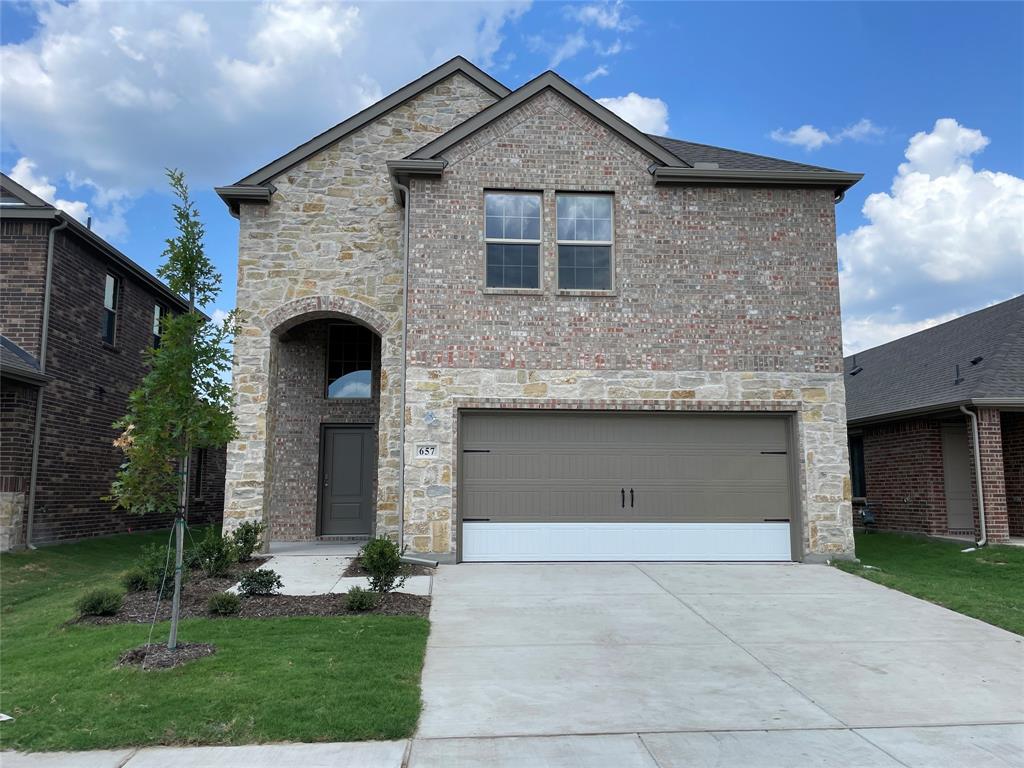 657 Chipper Trail Lavon, TX 75166 - Photo 2 of 24 a front view of a house with garden