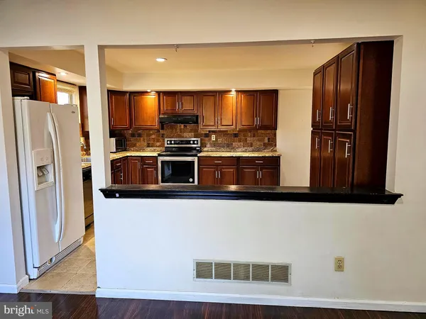 a kitchen with stainless steel appliances a refrigerator and a stove