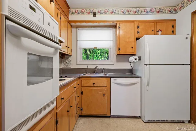 a kitchen with a sink a refrigerator and a stove