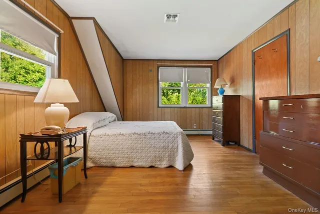 a bedroom with a bed and a large window