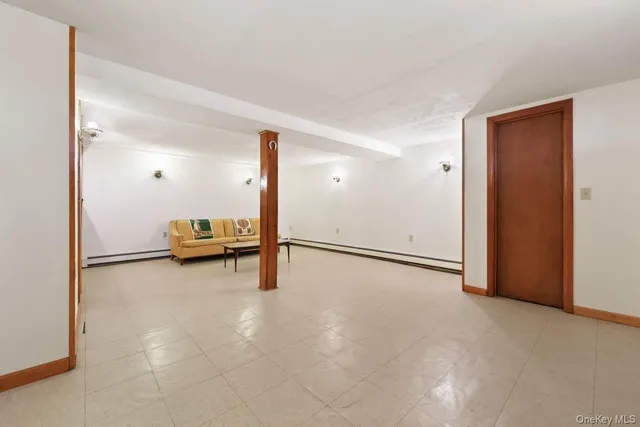 an empty room with wooden floor and white walls
