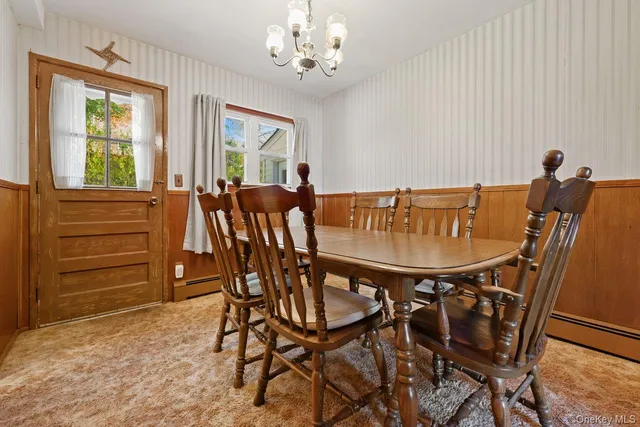 a view of a dining room with furniture and window