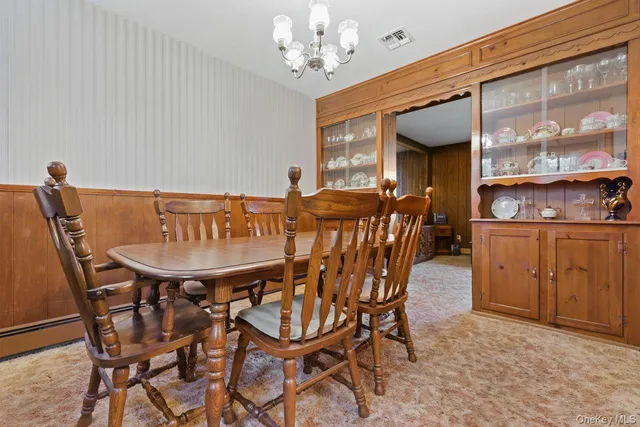 a view of a dining room with furniture and chandelier