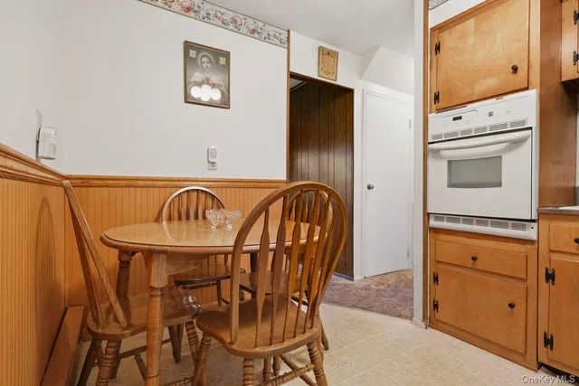 a kitchen with stainless steel appliances granite countertop a table and chairs