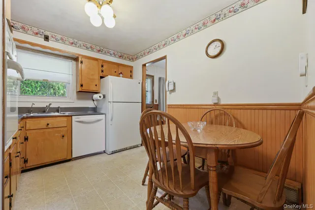 a kitchen with a table chairs stove and refrigerator