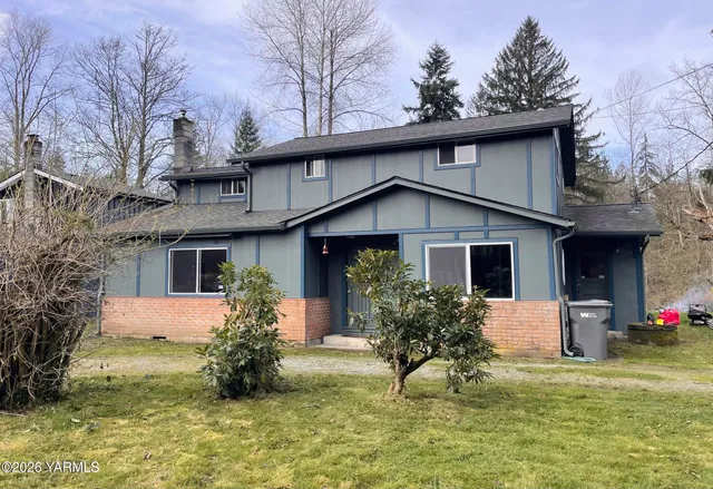 a house that has a tree in front of the house