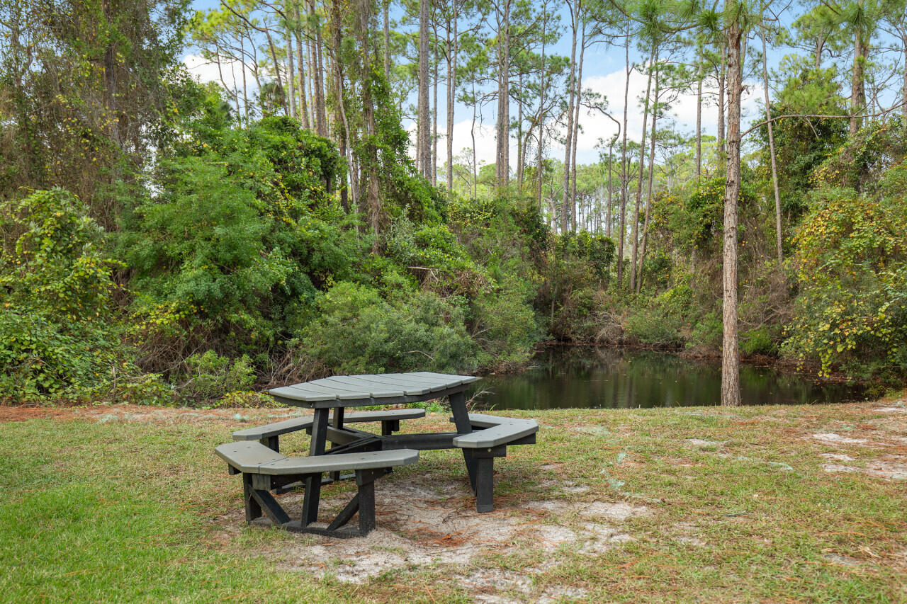 200 Sandestin Lane, Unit 616 Miramar Beach, FL 32550 - Photo 28 of 30 a view of a lake with a bench and trees