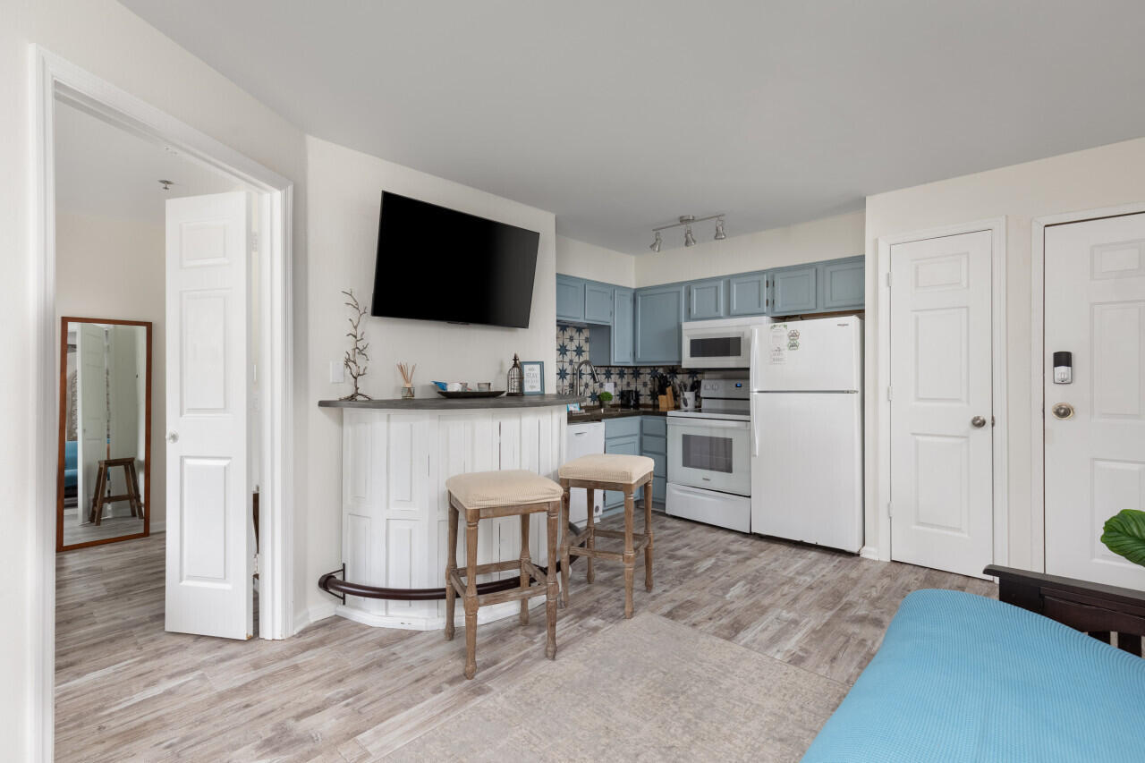 200 Sandestin Lane, Unit 616 Miramar Beach, FL 32550 - Photo 10 of 30 a kitchen with white cabinets and stainless steel appliances