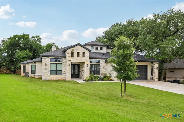 a front view of a house with a yard