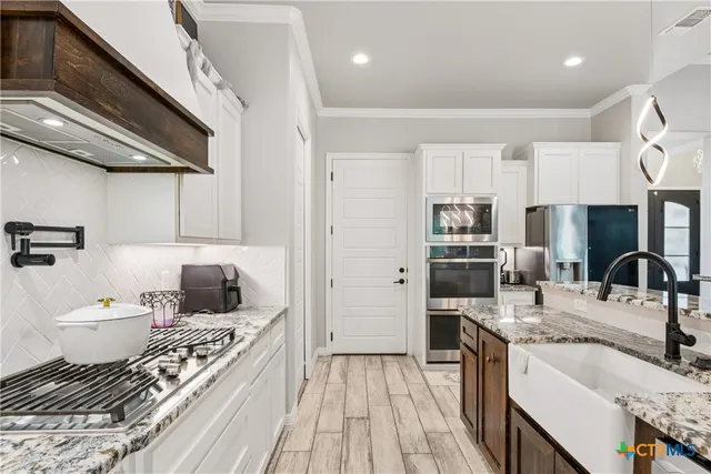 a large room with a lot of white furniture