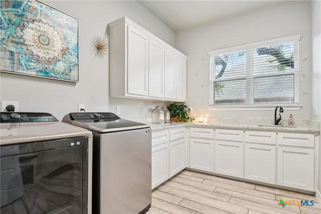 a kitchen with a sink stove and cabinets