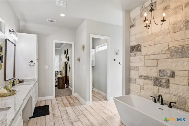 a bathroom with a tub sink and shower