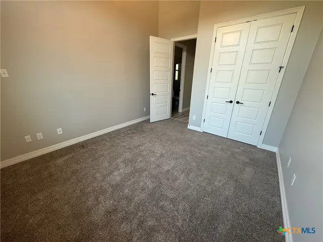an empty room with closet area