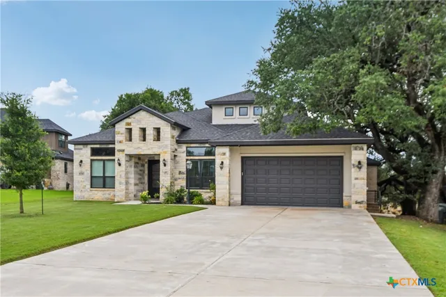 a front view of a house with a yard and garage